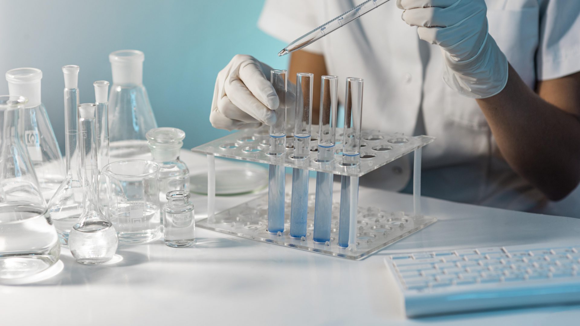 close-up-scientist-holding-tube-pipette