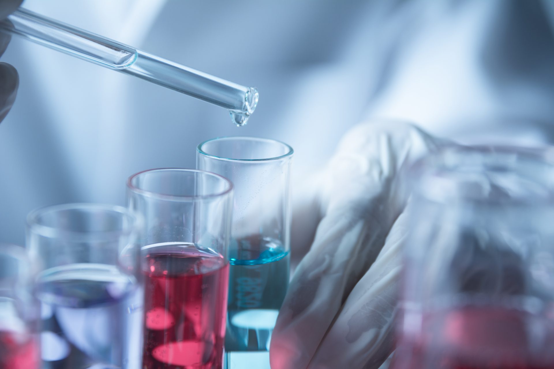 Researcher with glass laboratory chemical test tubes with liquid